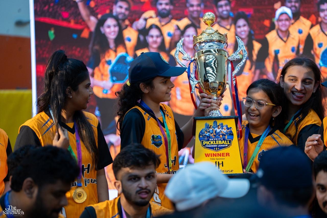 Champions holding the winner trophy